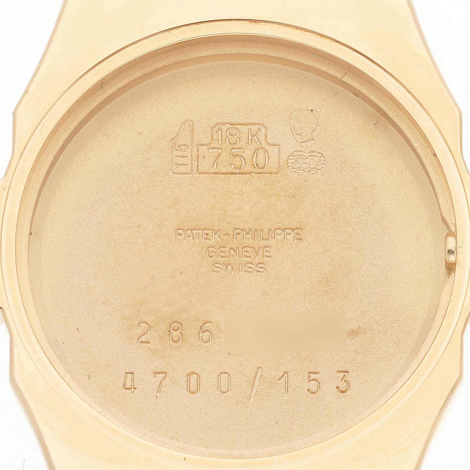 This image shows the inside case back of a Patek Philippe Nautilus 4700/153 Women's Yellow Gold Champagne Dial 4700/153 Women's Yellow Gold Champagne Dial watch, revealing engravings and gold hallmarks.