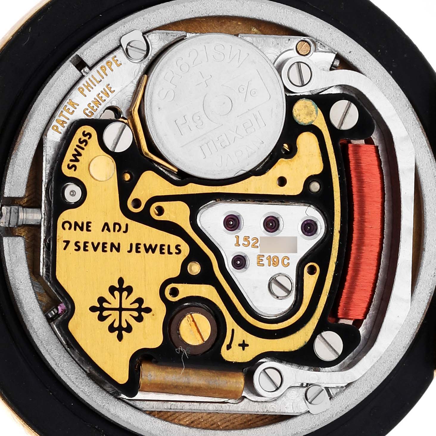 The image shows the backside of a Patek Philippe Nautilus 4700/153 Women's Yellow Gold Champagne Dial 4700/153 Women's Yellow Gold Champagne Dial watch, focusing on its intricate mechanical movement components.