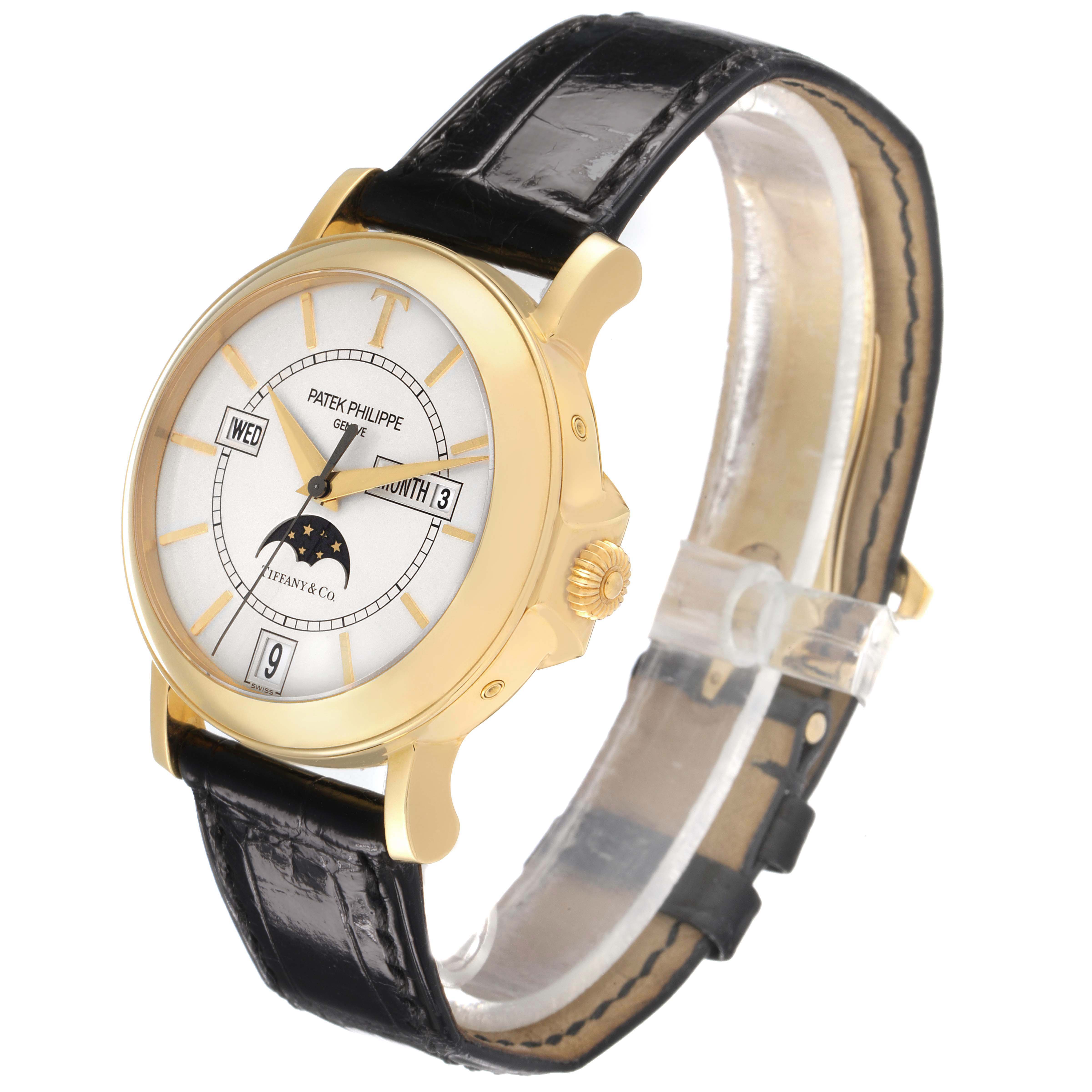 The Patek Philippe Complications 5150J Men's Yellow Gold Silver Dial watch is shown at a three-quarter angle, highlighting the dial, case, crown, and leather strap.