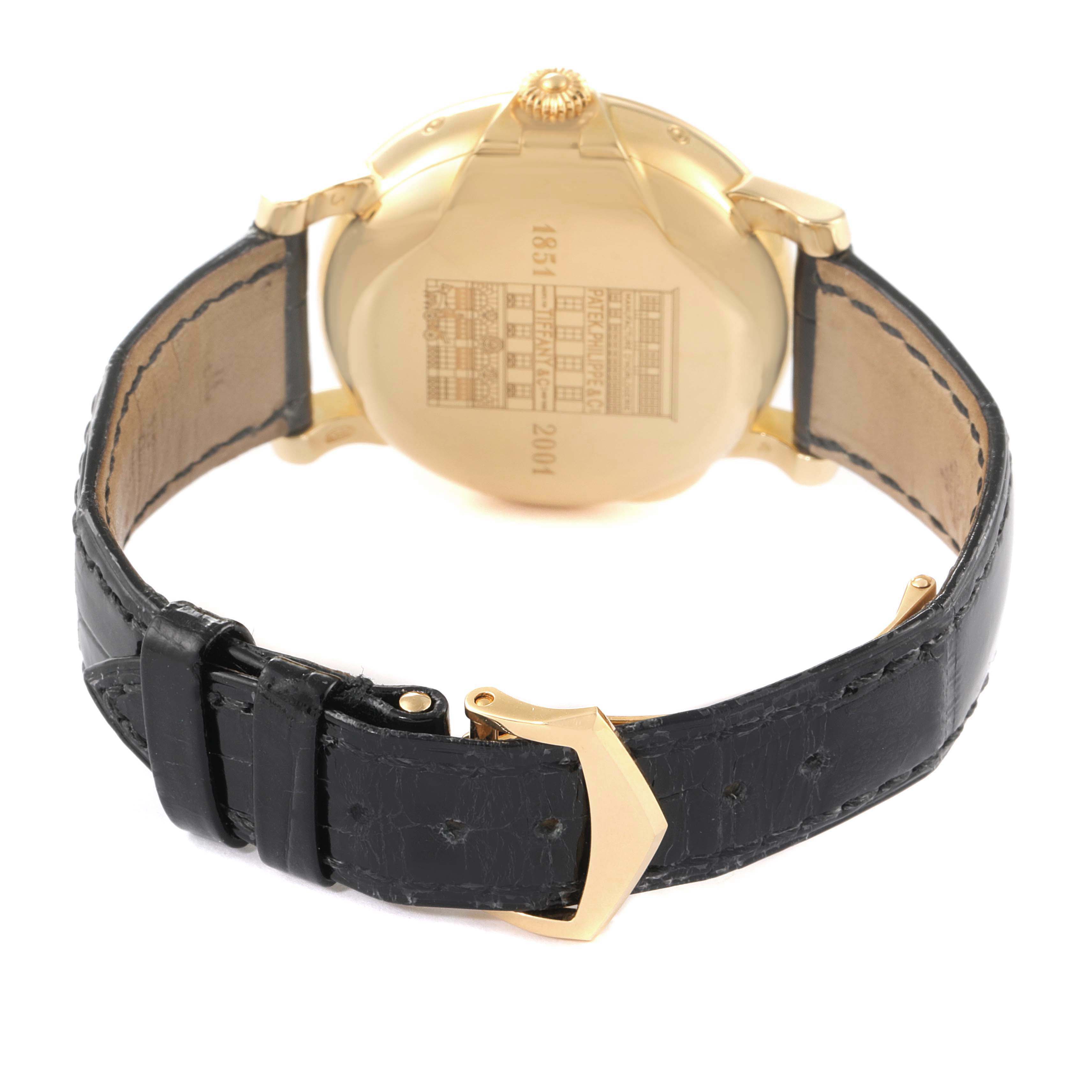 The image shows the back view of a Patek Philippe Complications 5150J Men's Yellow Gold Silver Dial watch, highlighting the case back and leather strap.