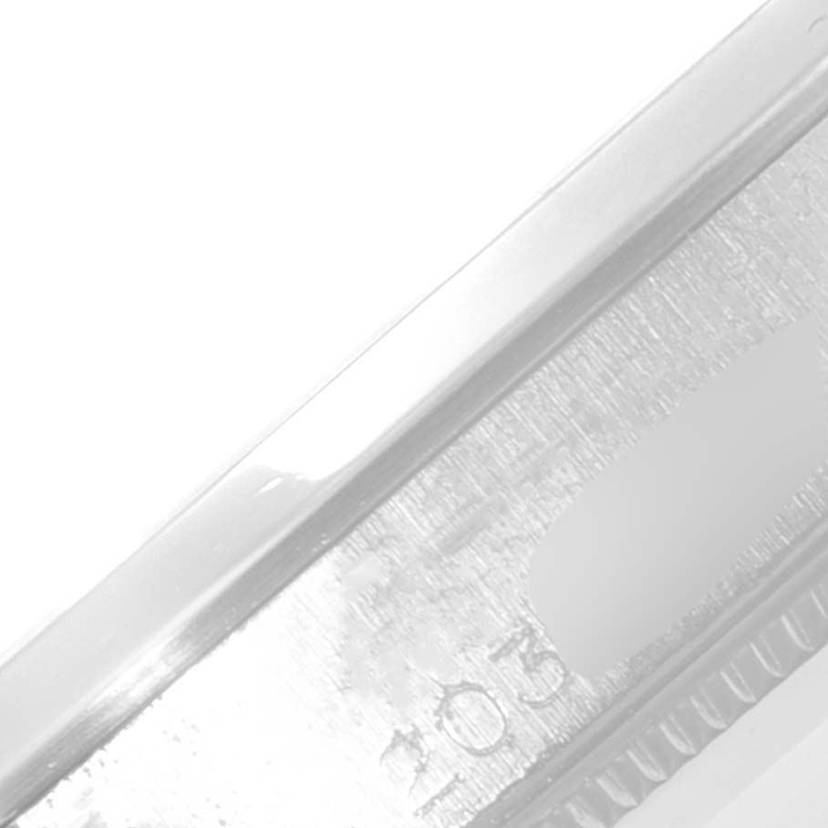 This image shows a close-up of the side of a Rolex Vintage Collection 5500 Men
s Stainless Steel Silver Dial 5500 Men
s Stainless Steel Silver Dial watch, highlighting the edge and part of the serial number.