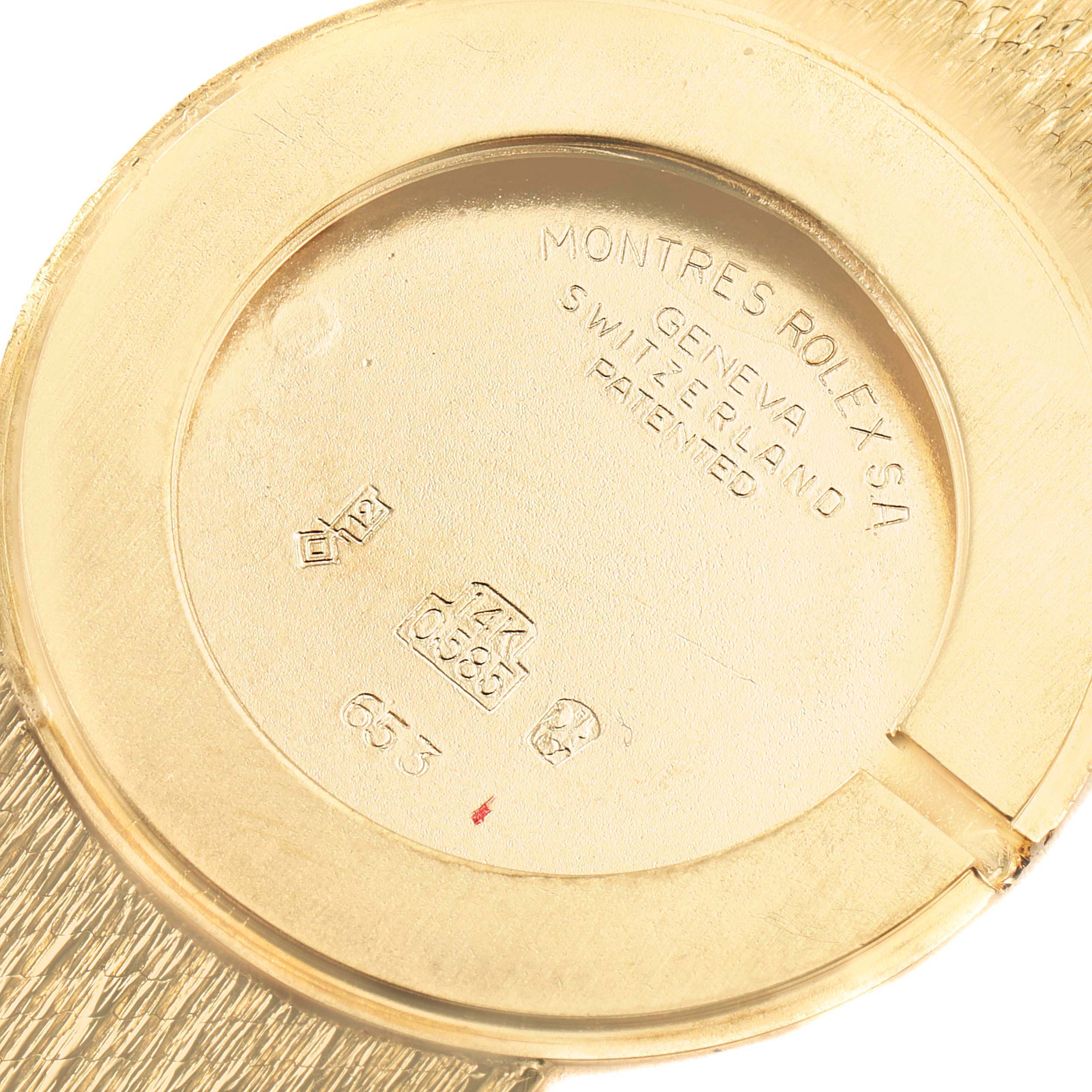The image shows the back case of a Rolex Cellini Men's Yellow Gold Champagne Dial Men's Yellow Gold Champagne Dial watch, including the inscriptions and hallmarks.