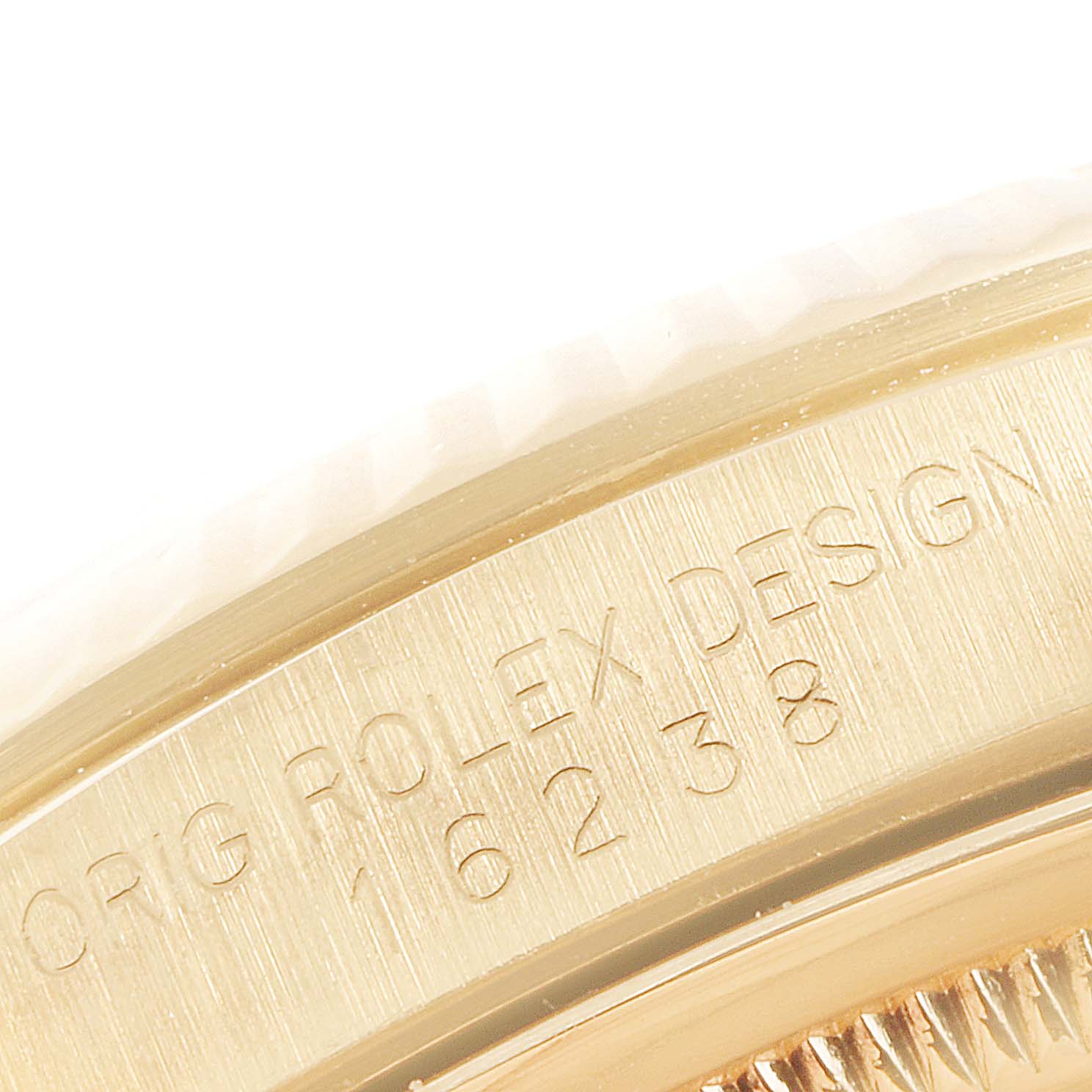 This image shows a close-up of the side of the Rolex President 16238 Men
s Yellow Gold Champagne Dial 16238 Men
s Yellow Gold Champagne Dial model watch, highlighting the engraved text and part of the bezel.