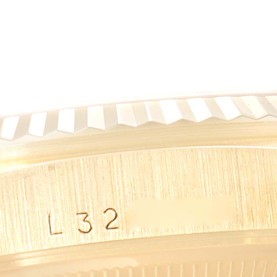 This close-up image shows the fluted bezel and a portion of the caseback with engraving of a Rolex President 16238 Men
s Yellow Gold Champagne Dial 16238 Men
s Yellow Gold Champagne Dial model watch.