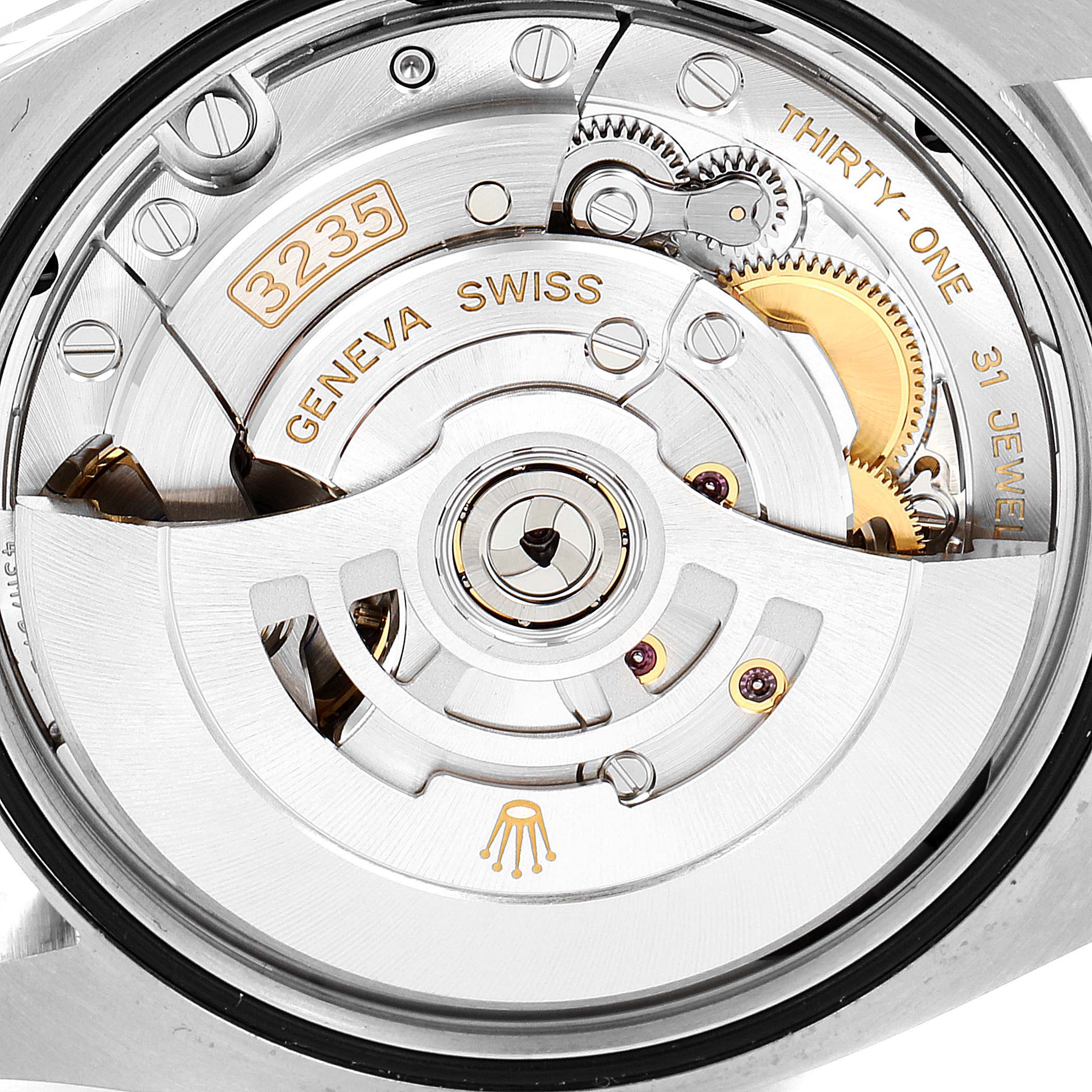 This image shows the movement of a Rolex Datejust 126200 Men's Stainless Steel Blue Dial 126200 Men's Stainless Steel Blue Dial watch, focusing on the intricate gears, jewels, and inscriptions.