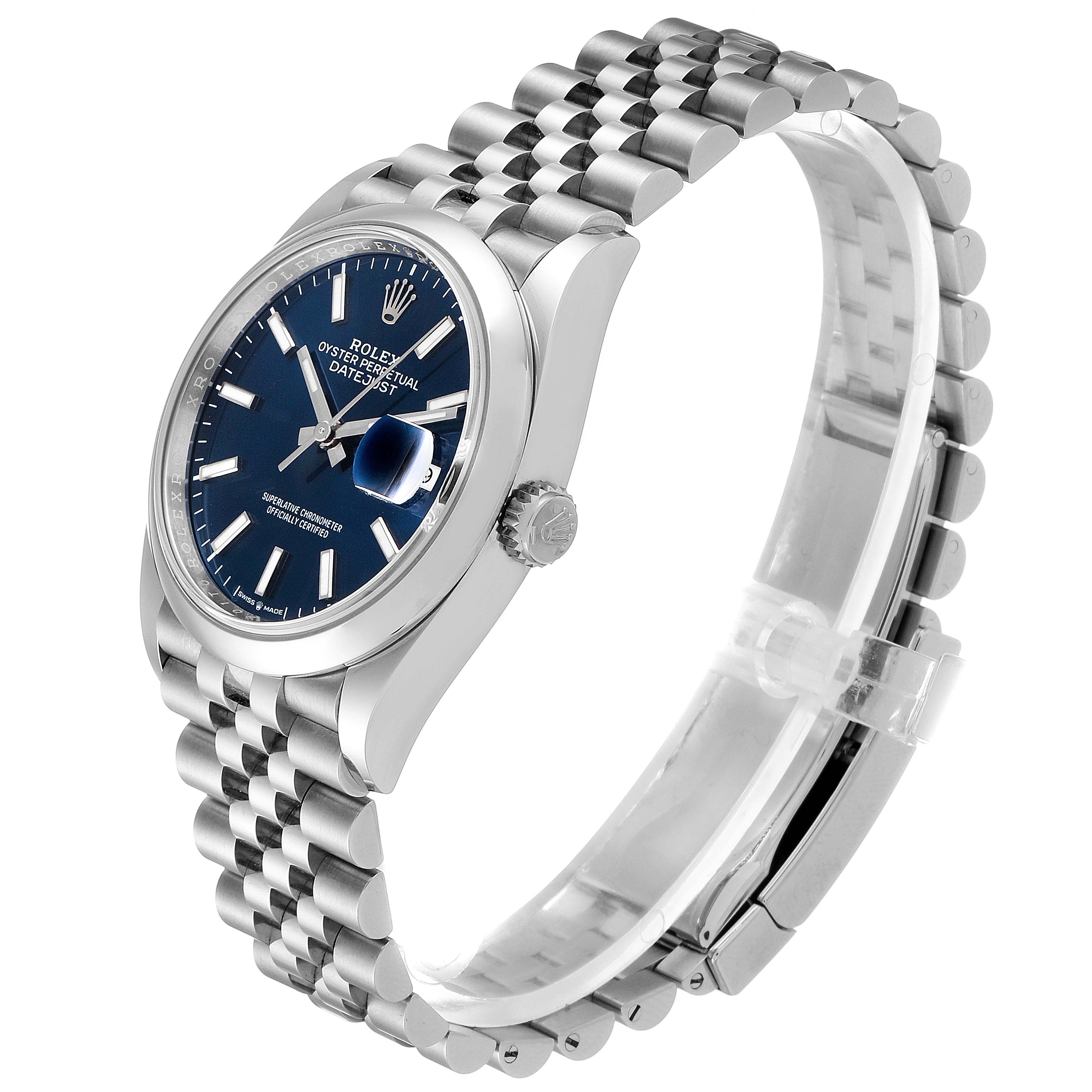 The image shows a side angle of a Rolex Datejust 126200 Men's Stainless Steel Blue Dial 126200 Men's Stainless Steel Blue Dial watch, highlighting its blue dial, crown, and jubilee bracelet.