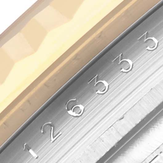 The image shows a close-up of the fluted bezel and part of the dial with date numbers on the Rolex Datejust 41 126333 Men's Steel and Gold (two tone) Black Dial 126333 Men's Steel and Gold (two tone) Black Dial.