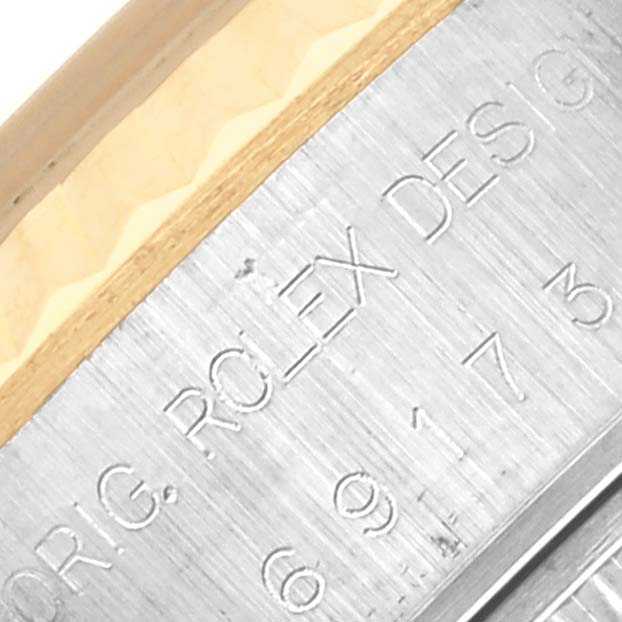 The image shows a close-up of the side engraving on the bezel of a Rolex Datejust 69173 Women's Steel and Gold (two tone) White Dial 69173 Women's Steel and Gold (two tone) White Dial watch.