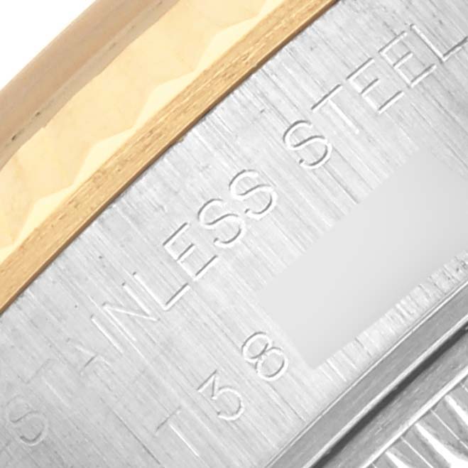 The image shows a close-up of the bezel and edge of the casing of a Rolex Datejust 69173 Women's Steel and Gold (two tone) White Dial 69173 Women's Steel and Gold (two tone) White Dial watch with "stainless steel" engraved.