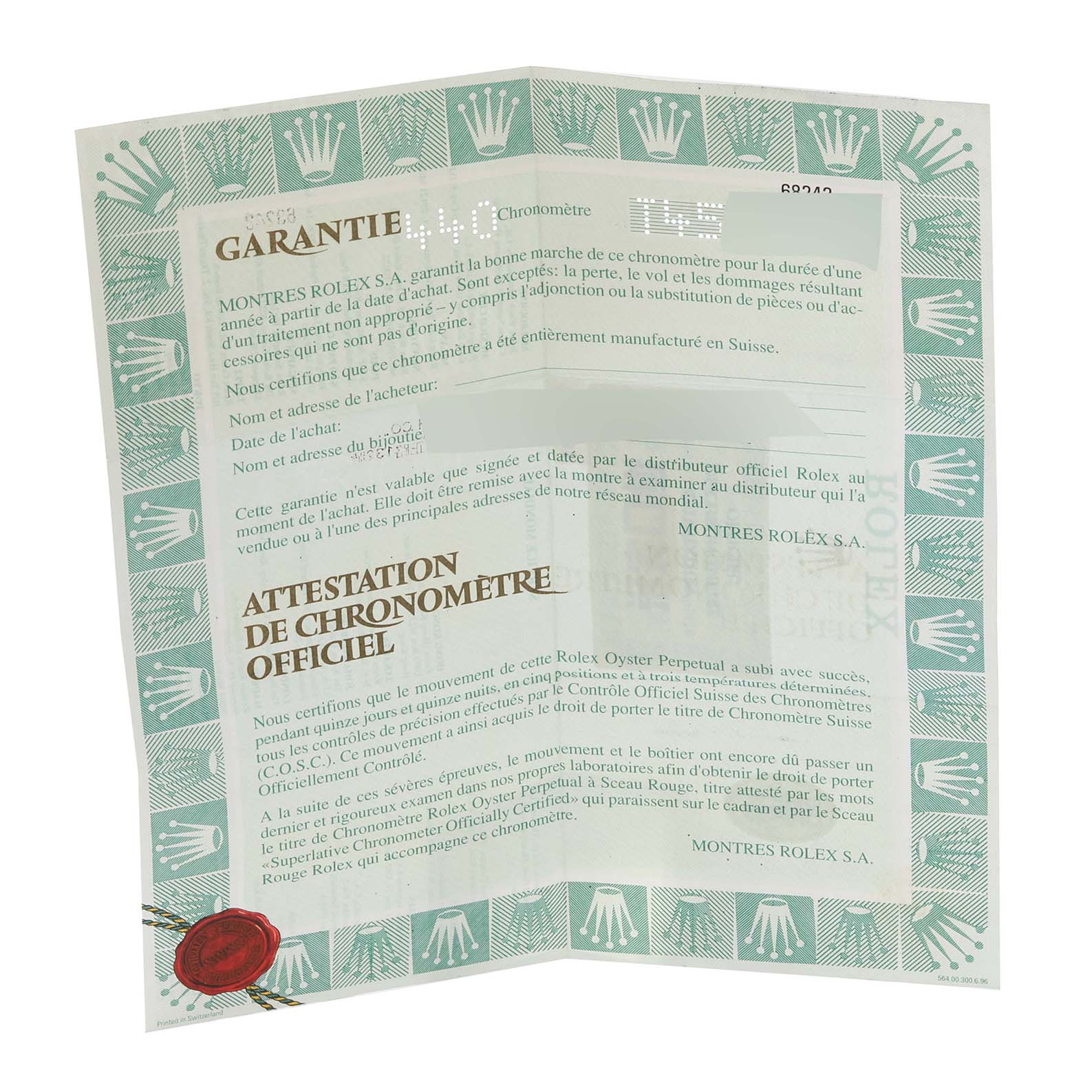 The image shows a warranty certificate for a Mid-Size model by Rolex from a top-down angle.