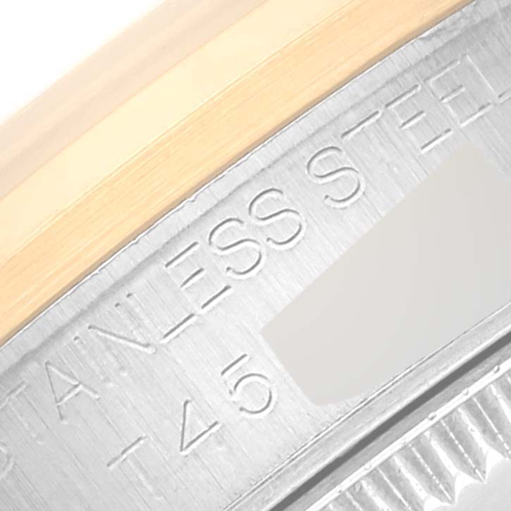 This close-up image shows a partial view of the stainless steel and gold bezel of a Mid-Size Rolex watch.