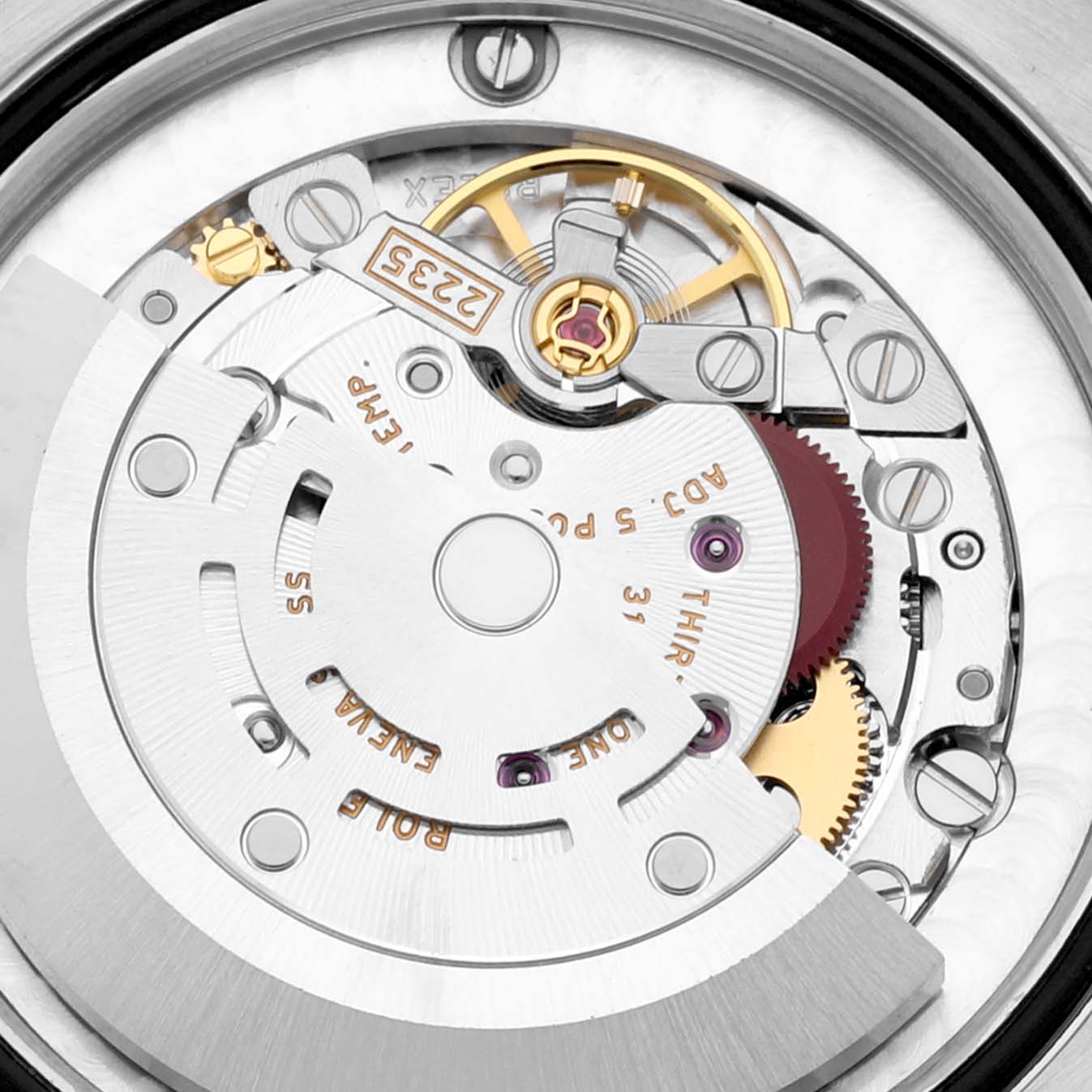 The image shows a close-up view of the movement mechanism inside a Mid-Size Rolex watch, highlighting gears and components.