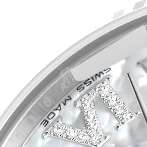 This close-up image of a Rolex Mid-Size 178274 Women
s Stainless Steel Mother of Pearl Dial 178274 Women
s Stainless Steel Mother of Pearl Dial watch shows a partial view of its dial, including the "Swiss Made" label and diamond-encrusted Roman numeral.