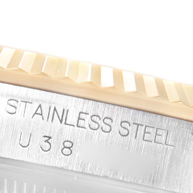 The image shows a close-up of the bezel and engraved case side of the Rolex Datejust 16233 Men's Steel and Gold (two tone) White Dial 16233 Men's Steel and Gold (two tone) White Dial watch.