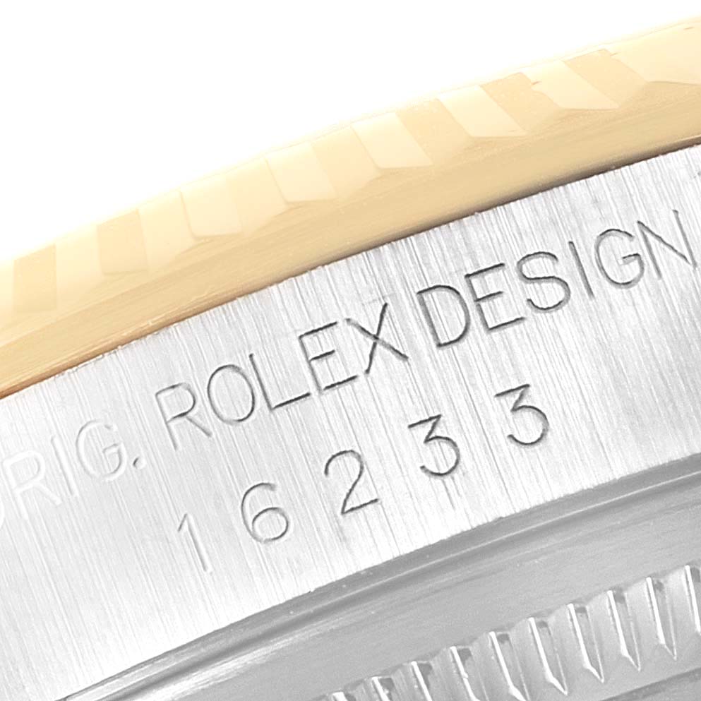 This image shows a close-up of the side engraving and partial bezel of a Rolex Datejust 16233 Men's Steel and Gold (two tone) White Dial 16233 Men's Steel and Gold (two tone) White Dial model, showcasing the model number 16233.