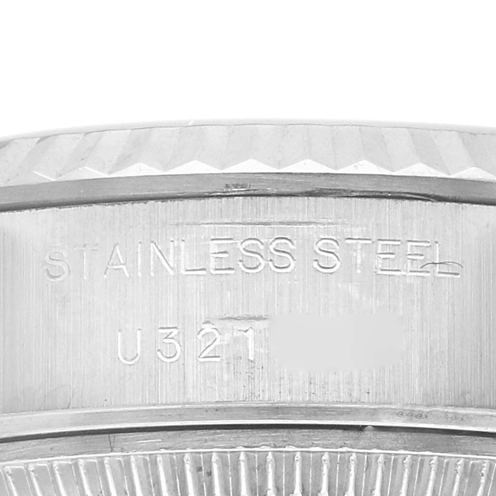 This image shows the side view of the serial number and "STAINLESS STEEL" engraving on a Rolex Datejust 69174 Women's Stainless Steel White Dial 69174 Women's Stainless Steel White Dial watch case.