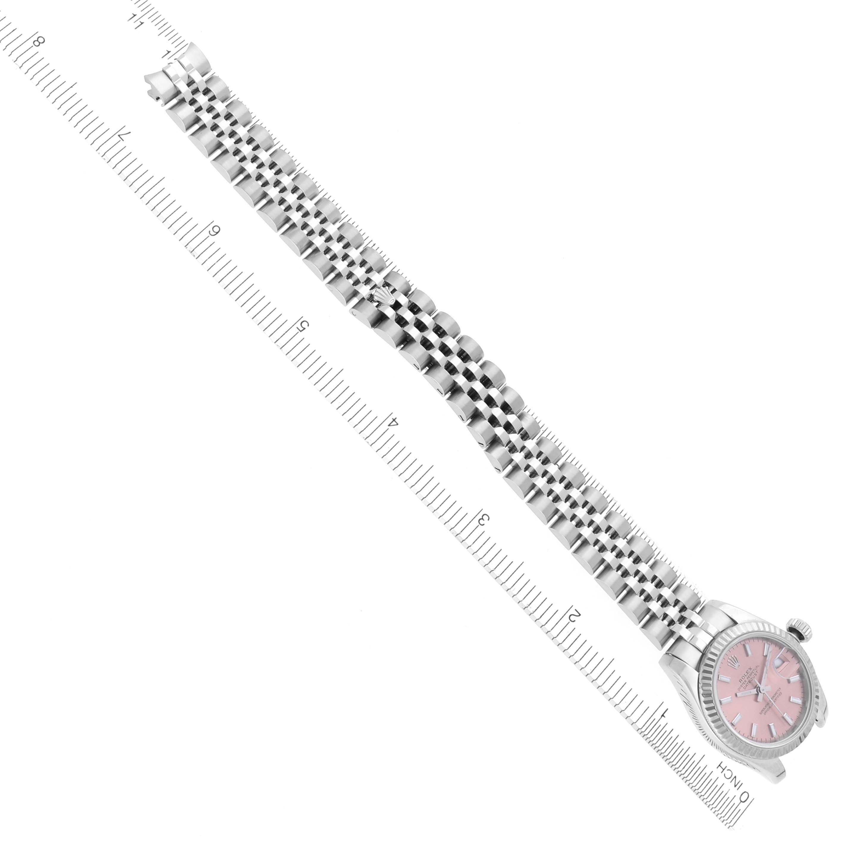 The image shows a Rolex Datejust 179174 Women's Stainless Steel Pink Dial 179174 Women's Stainless Steel Pink Dial watch laid flat, featuring its bracelet and pink dial face, with a ruler for size reference.