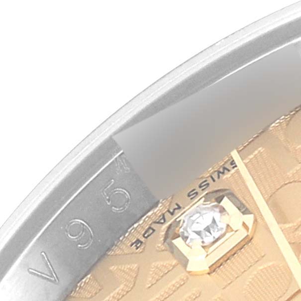 This image shows a macro close-up angle of a Rolex Datejust 116233 Men's Steel and Gold (two tone) Champagne Dial 116233 Men's Steel and Gold (two tone) Champagne Dial dial and part of the bezel, highlighting a diamond marker.