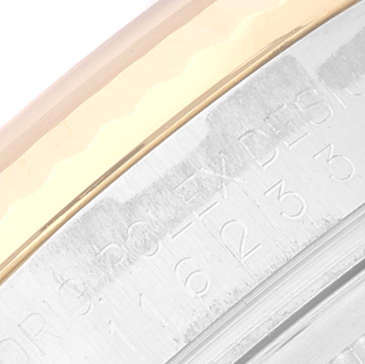 The image shows a close-up of the Rolex Datejust 116233 Men's Steel and Gold (two tone) Champagne Dial 116233 Men's Steel and Gold (two tone) Champagne Dial model's bezel and case edge, highlighting part of the engraved details.