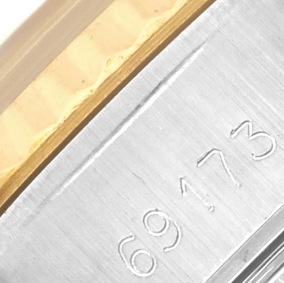 The image shows a close-up of the side of a Rolex Datejust 69173 Women's Steel and Gold (two tone) Champagne Dial 69173 Women's Steel and Gold (two tone) Champagne Dial, highlighting the serial number and part of the bezel.