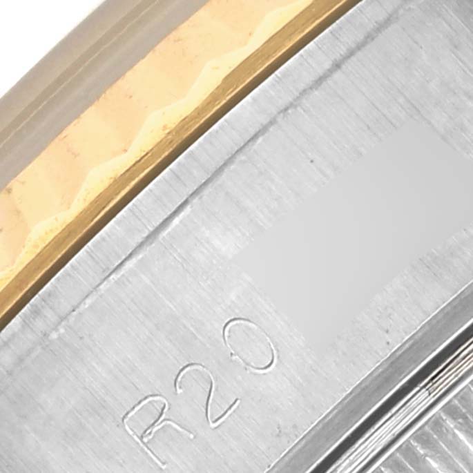 The image shows a close-up of the bezel and part of the case edge of a Rolex Datejust 69173 Women's Steel and Gold (two tone) Champagne Dial 69173 Women's Steel and Gold (two tone) Champagne Dial, highlighting the metal texture and engraving.