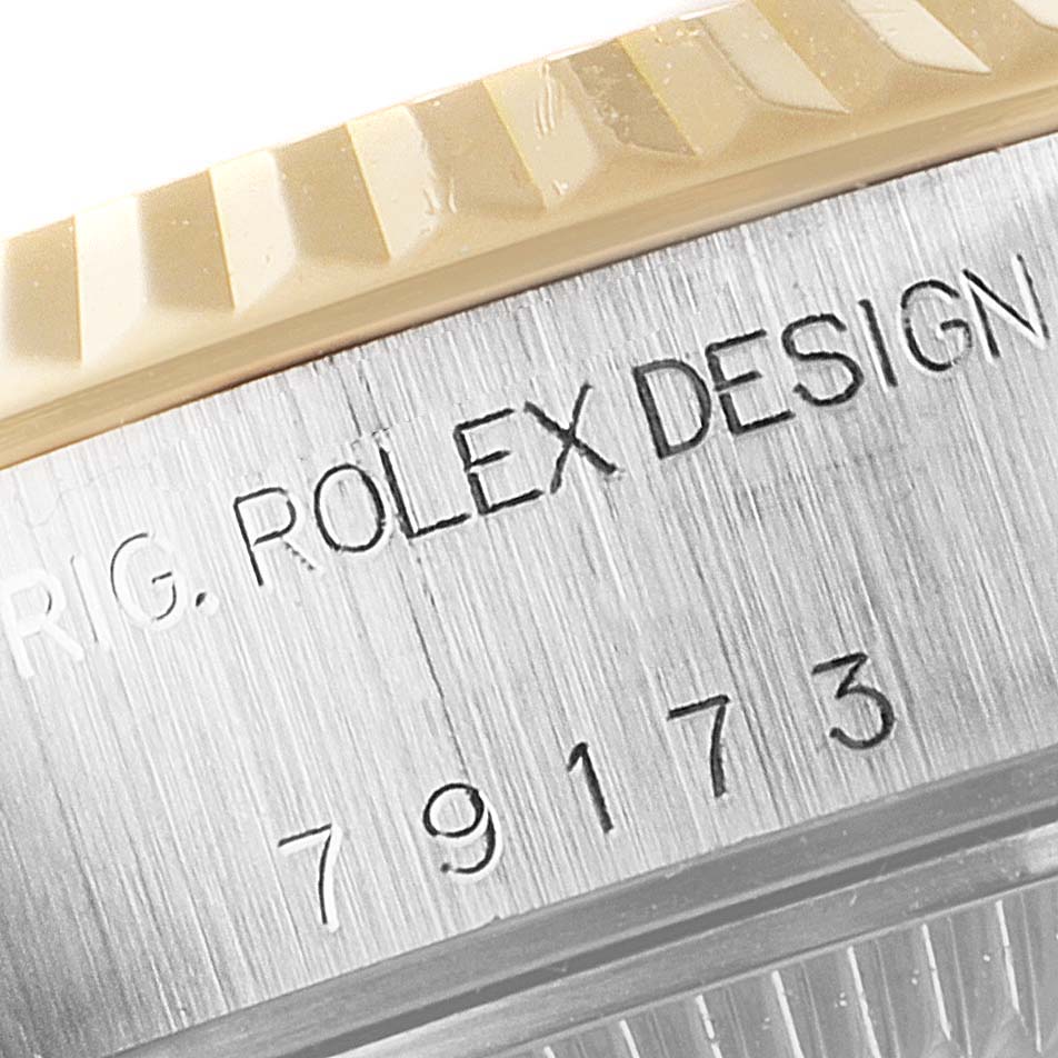 This image shows a close-up of the bezel and engraved serial number on a Rolex Datejust 79173 Women
s Steel and Gold (two tone) Champagne Dial 79173 Women
s Steel and Gold (two tone) Champagne Dial watch.