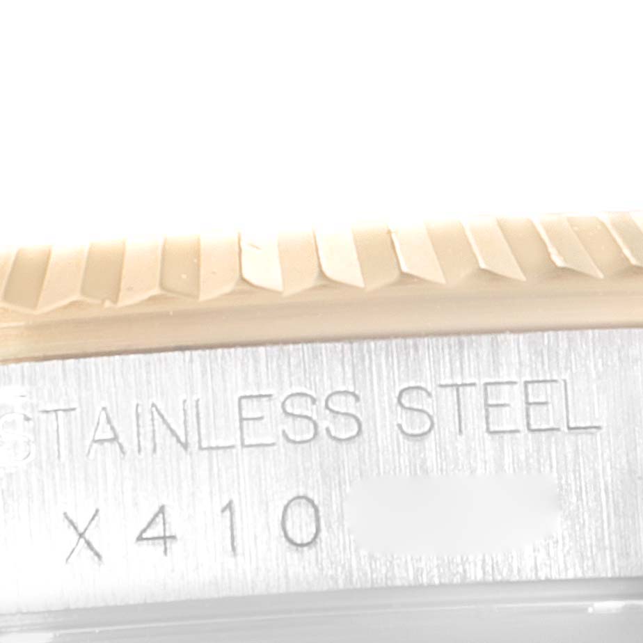 The image shows a close-up of the engraved stainless steel bezel edge of the Rolex Datejust 16233 Men's Steel and Gold (two tone) Champagne Dial 16233 Men's Steel and Gold (two tone) Champagne Dial watch.