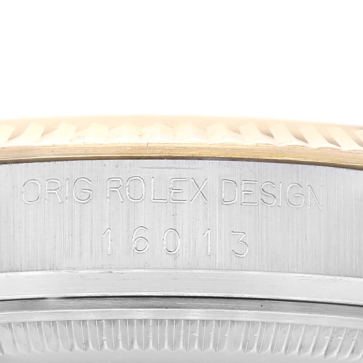 The image shows a close-up of the case side and bezel of a Rolex Datejust 16013 Men's Steel and Gold (two tone) Champagne Dial 16013 Men's Steel and Gold (two tone) Champagne Dial model with the engraving "ORIG ROLEX DESIGN 16013".