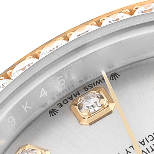 This close-up image of a Rolex Datejust 279383 Women's Steel and Gold (two tone) Silver Dial 279383 Women's Steel and Gold (two tone) Silver Dial watch shows part of the bezel, dial with diamond markers, and text indicating "Swiss Made."