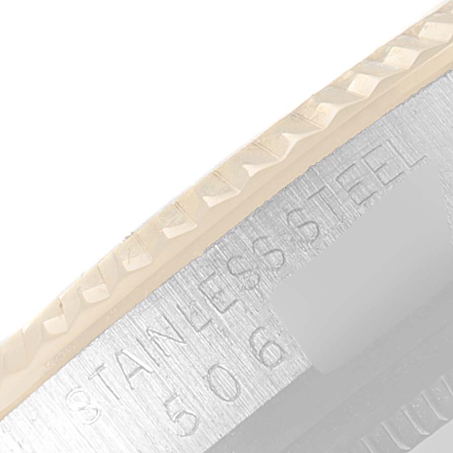 This close-up image shows the edge and stainless steel part of the bezel of a Rolex Vintage Collection 1601 Men's Steel and Gold (two tone) Silver Dial 1601 Men's Steel and Gold (two tone) Silver Dial watch.