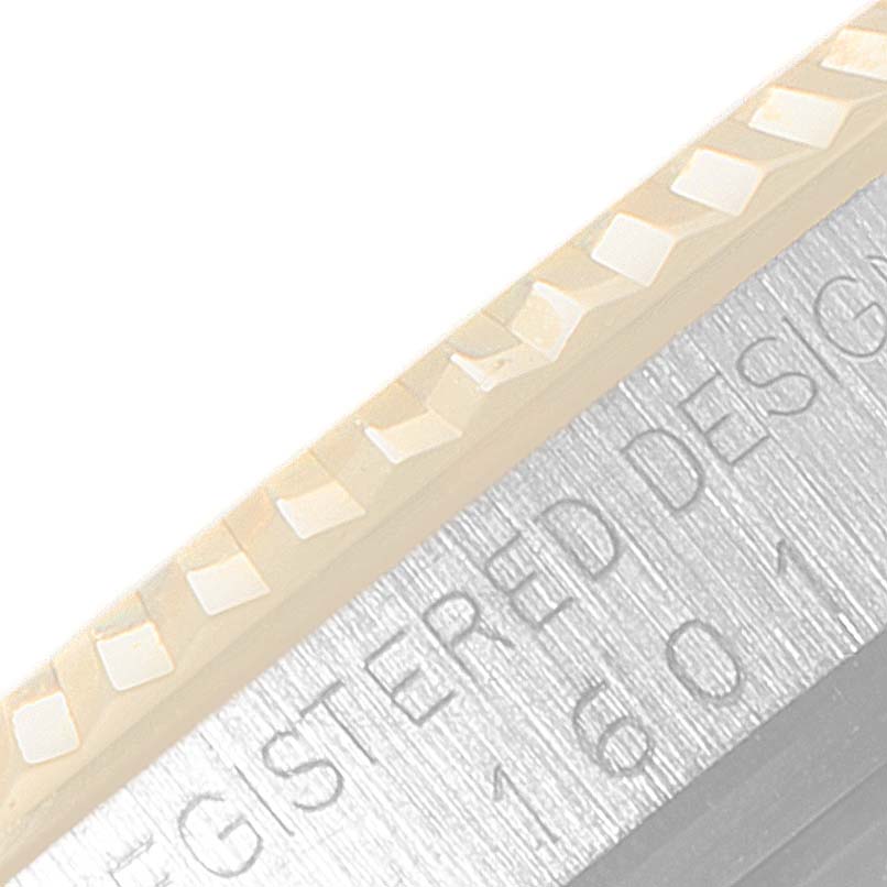 The image shows a close-up view of the bezel edge and engraved text on the casing of a Rolex Vintage Collection 1601 Men's Steel and Gold (two tone) Silver Dial 1601 Men's Steel and Gold (two tone) Silver Dial model.