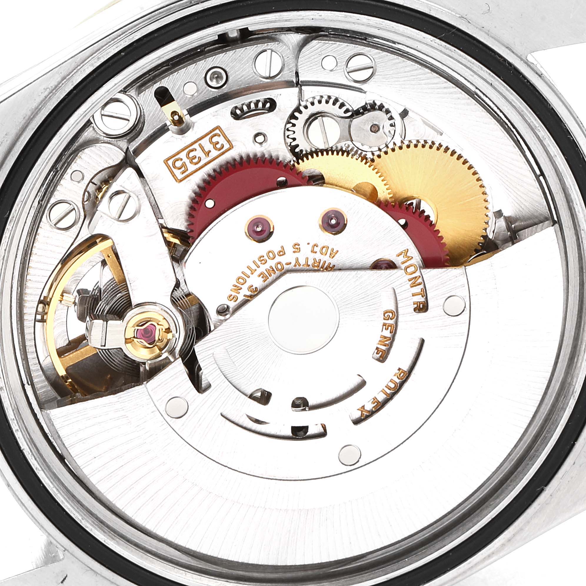 This image shows a close-up of the internal mechanism of a Rolex Datejust 16233 Men's Steel and Gold (two tone) Blue Dial 16233 Men's Steel and Gold (two tone) Blue Dial watch, highlighting gears, screws, and intricate details.
