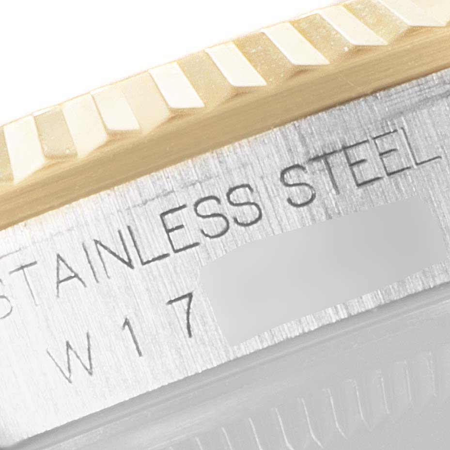 Close-up of a Rolex Datejust 16233 Men's Steel and Gold (two tone) White Dial 16233 Men's Steel and Gold (two tone) White Dial watch, focusing on the fluted bezel and part of the case with "STAINLESS STEEL" engraving.