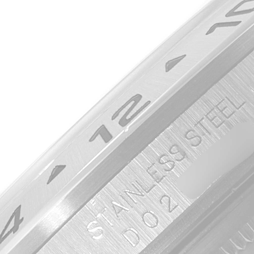 The image shows a close-up view of the stainless steel bezel of a Rolex Explorer 16570 Men's Stainless Steel White Dial 16570 Men's Stainless Steel White Dial watch, highlighting the engraved numerals and text.
