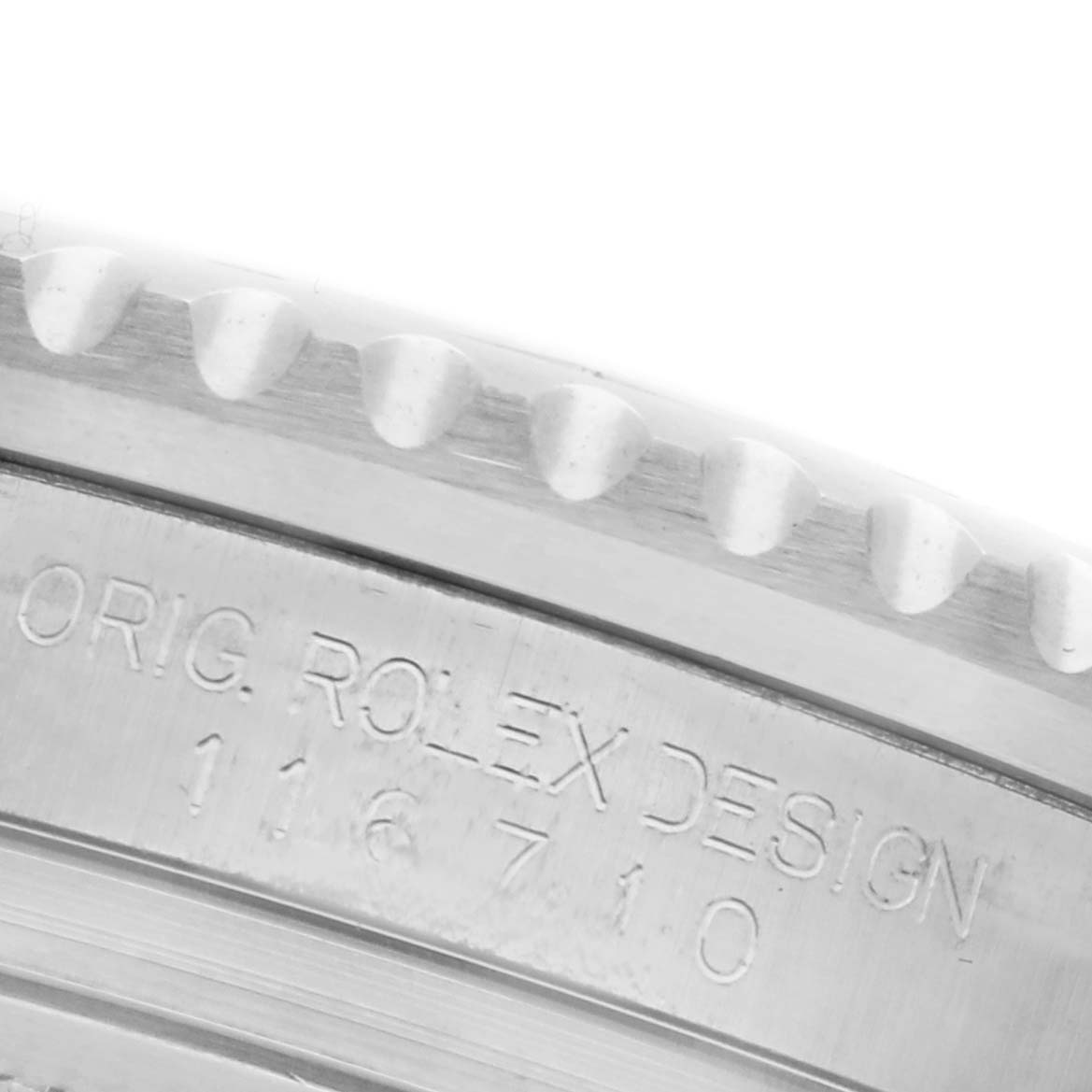 The image shows a close-up of the side engraving on the bezel of a Rolex GMT-Master 116710LN Men
s Stainless Steel Black Dial 116710LN Men
s Stainless Steel Black Dial.