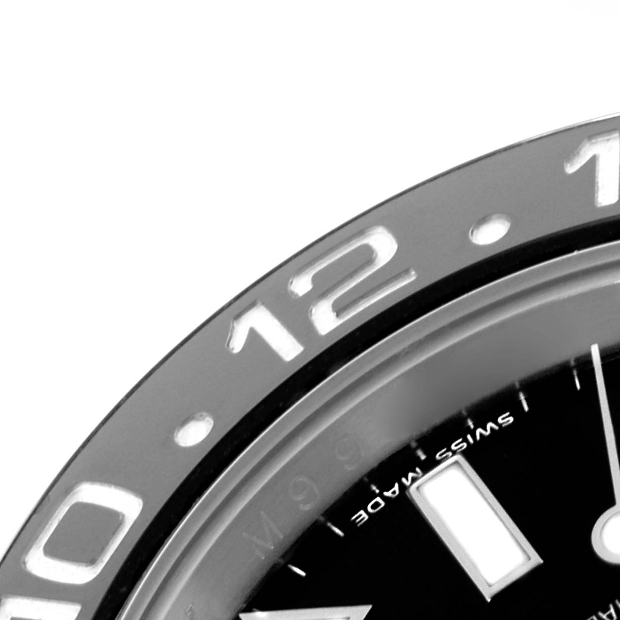 The image shows a close-up view of the bezel and part of the dial of a Rolex GMT-Master 116710LN Men
s Stainless Steel Black Dial 116710LN Men
s Stainless Steel Black Dial watch, highlighting the 12 and 10 numerals.