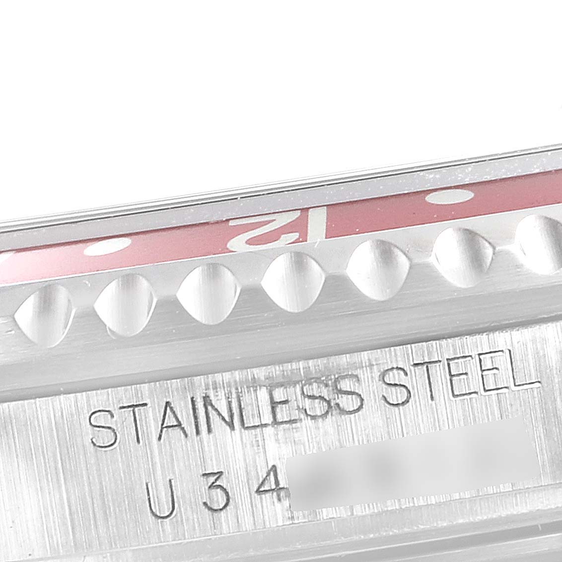 The image shows a close-up of the bezel and case side of a Rolex GMT-Master 16710 Men
s Stainless Steel Black Dial 16710 Men
s Stainless Steel Black Dial, highlighting the "STAINLESS STEEL" engraving.