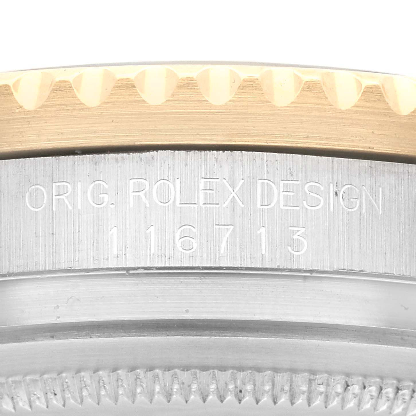 This close-up shows the side of the bezel and the case with the model number and "ORIG. ROLEX DESIGN" on the Rolex GMT-Master 116713 Men's Steel and Gold (two tone) Black Dial 116713 Men's Steel and Gold (two tone) Black Dial.