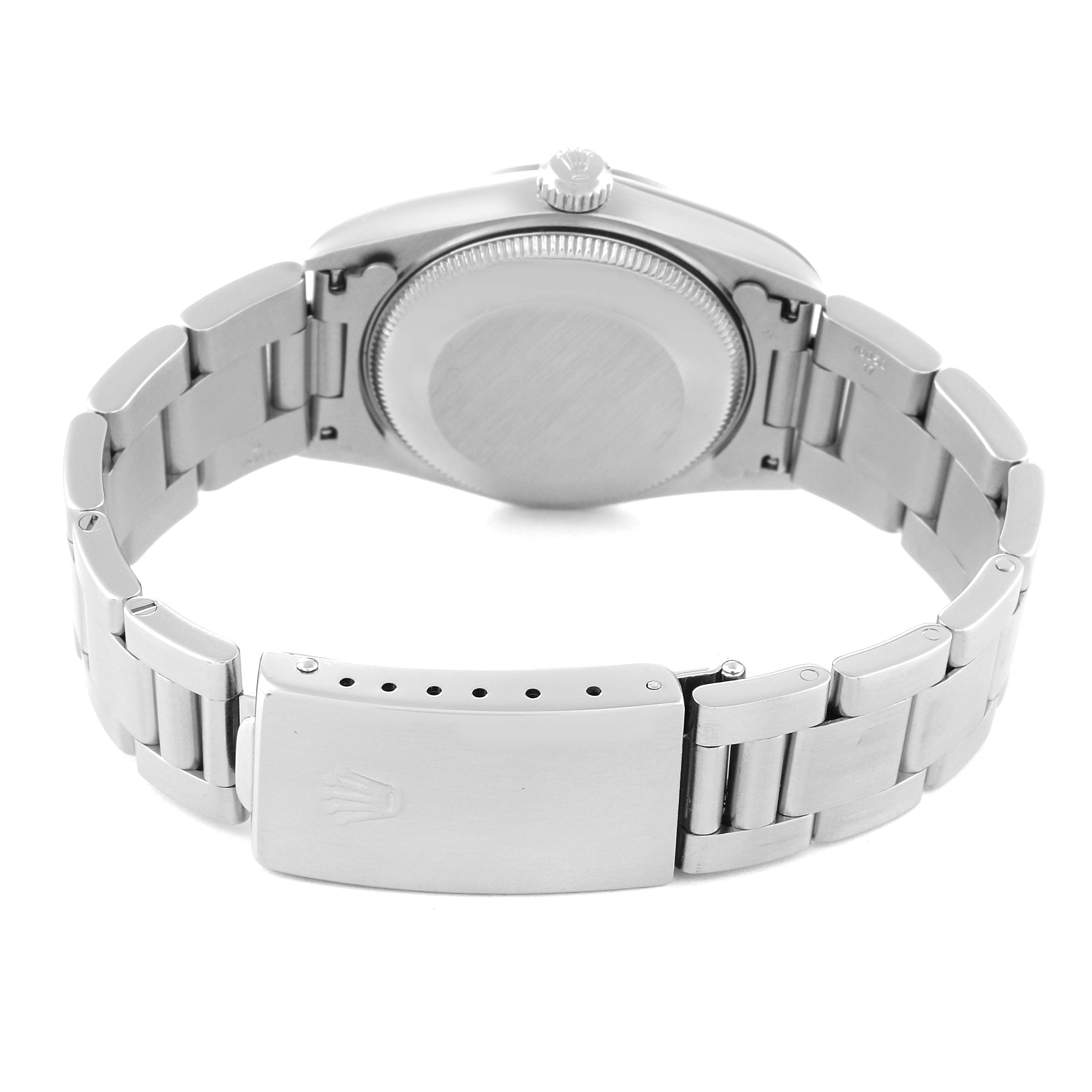 The image shows the back view of a Mid-Size Rolex watch, featuring its case back, crown, and bracelet with a clasp.