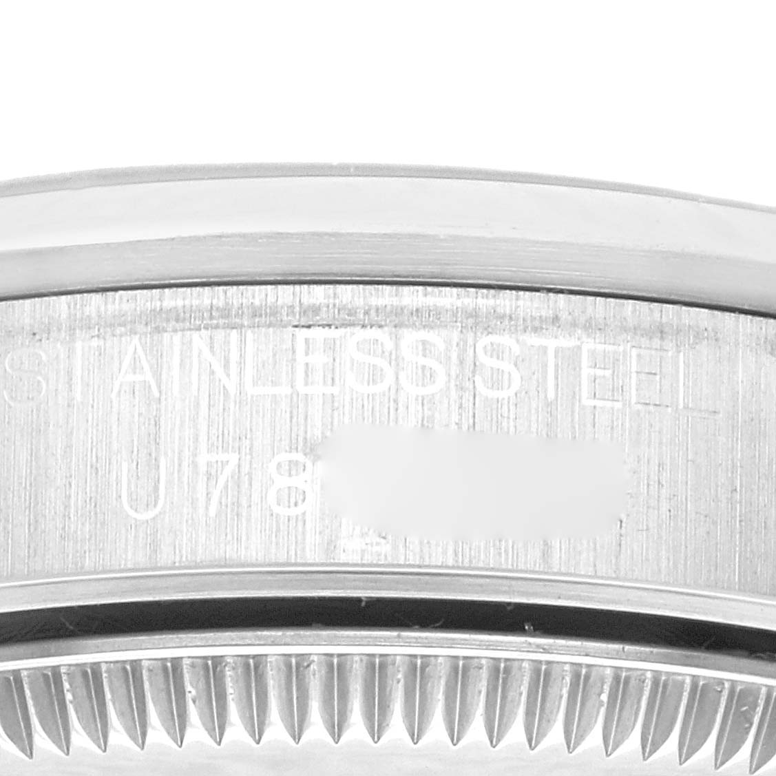 The image shows a close-up of the stainless steel case back and part of the grooved bezel of a Rolex Mid-Size 68240 Women's Stainless Steel Pink Dial 68240 Women's Stainless Steel Pink Dial watch.