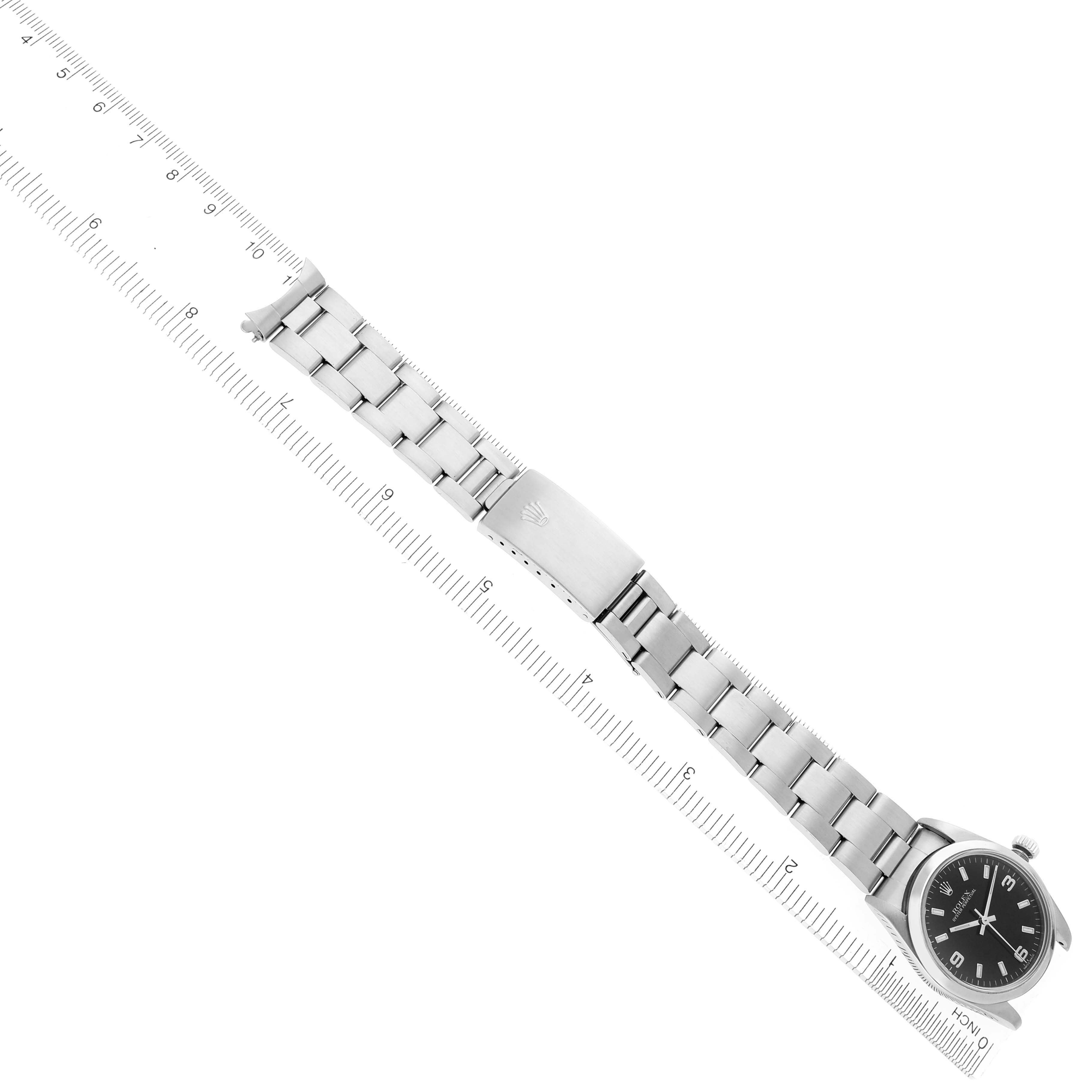 The Rolex Mid-Size 77080 Women's Stainless Steel Black Dial 77080 Women's Stainless Steel Black Dial watch is shown from a top-down angle, highlighting the dial, bracelet, and clasp with a measuring scale.