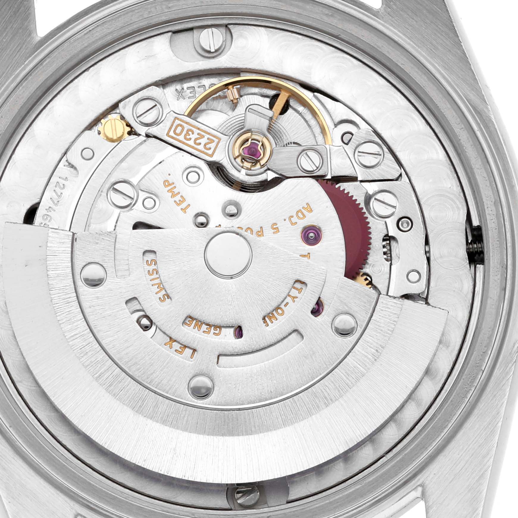 The image shows a close-up view of the movement inside a mid-size Rolex, highlighting gears and the rotor mechanism.