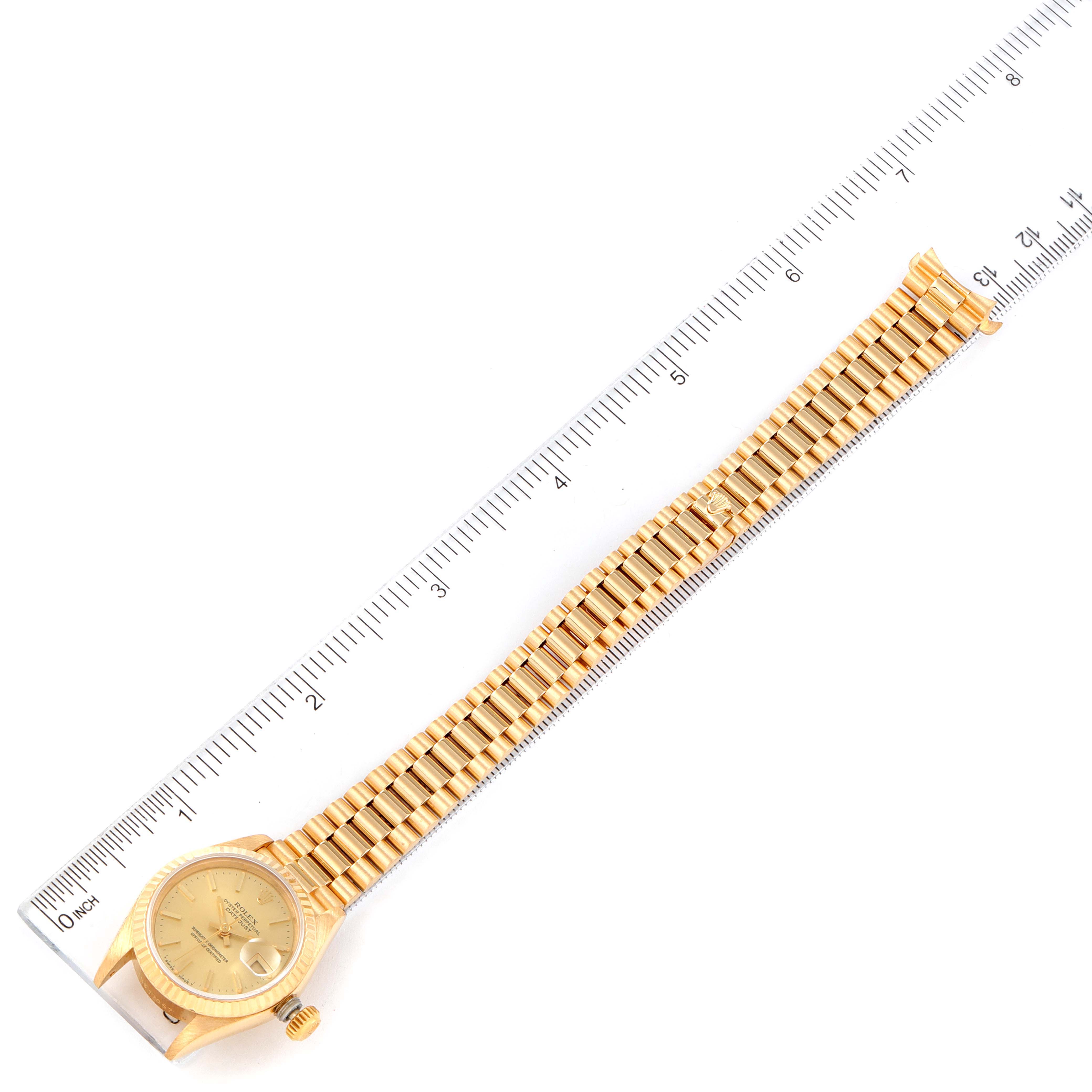 The image shows a Rolex President 69178 Women's Yellow Gold Champagne Dial 69178 Women's Yellow Gold Champagne Dial model watch laid flat and measured against a ruler, displaying the face and full bracelet.