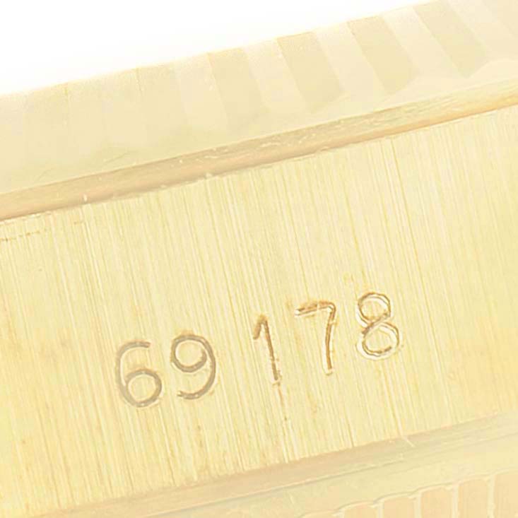 This image shows a close-up of the serial number on the case of a Rolex President 69178 Women
s Yellow Gold Champagne Dial 69178 Women
s Yellow Gold Champagne Dial model watch.