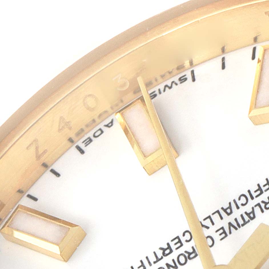 The image shows a close-up of the dial and markers of a Rolex President 179178 Women
s Yellow Gold White Dial 179178 Women
s Yellow Gold White Dial model watch at an angle capturing part of the white face and gold bezel.