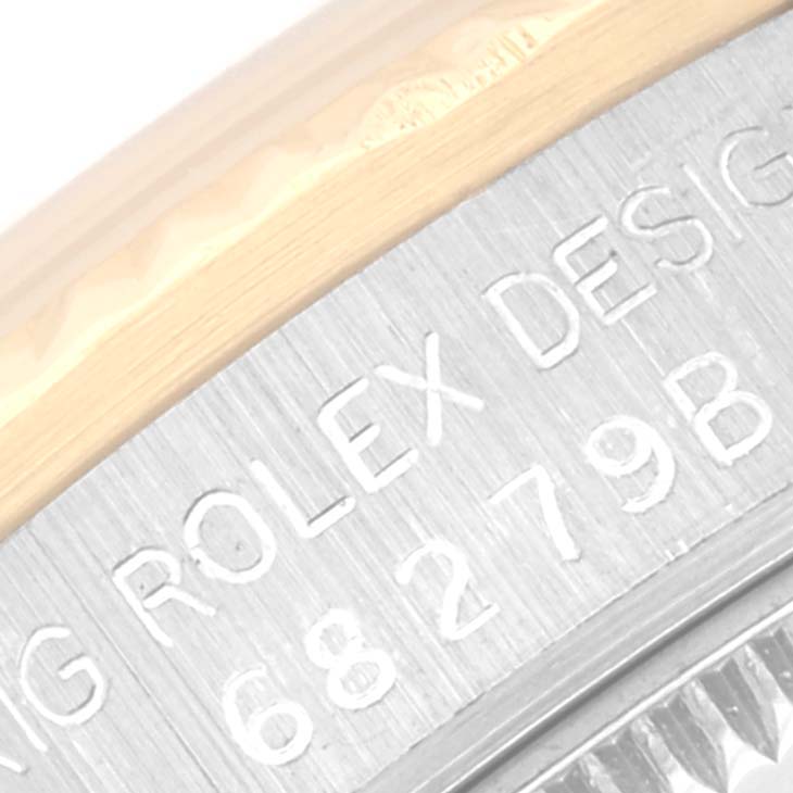 The image shows a close-up of the engraving on the side of the bezel and case of a Rolex President 68279 Women's White Gold Champagne Dial 68279 Women's White Gold Champagne Dial model watch.