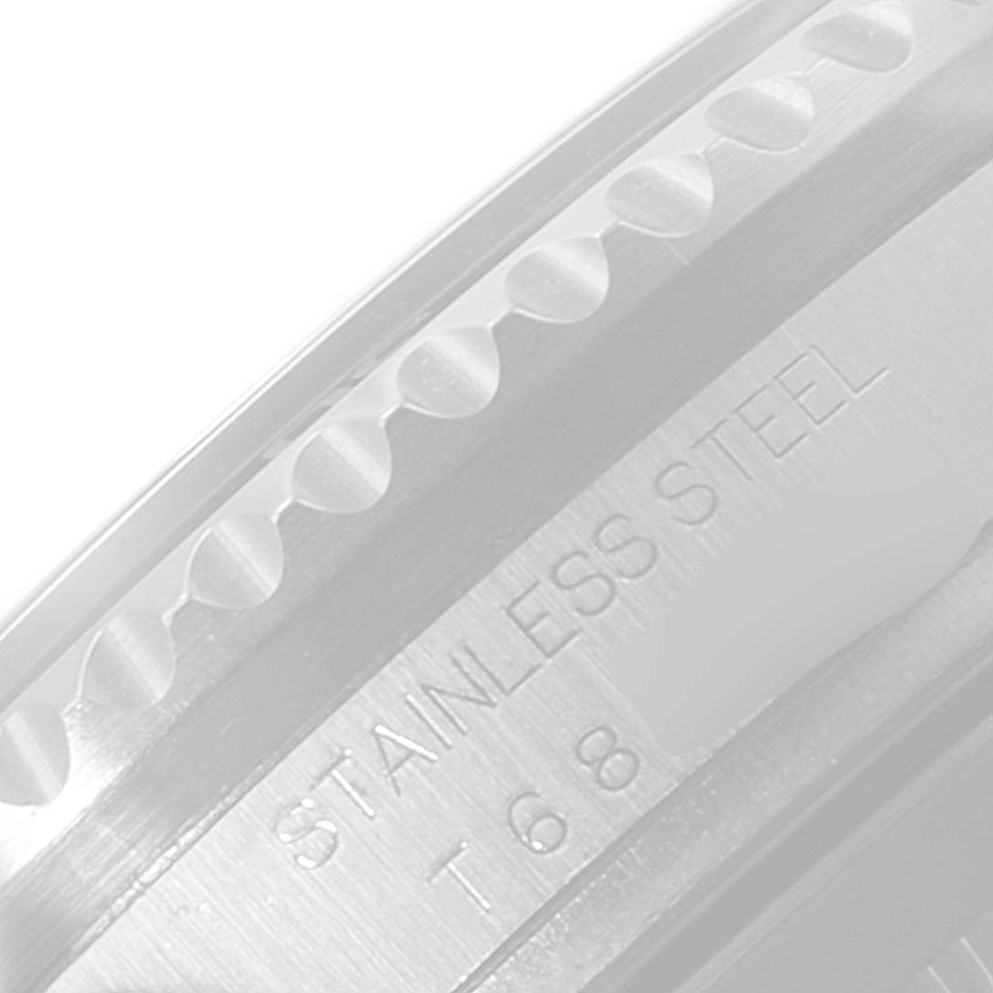 This image shows a close-up of the side of the bezel and case of a Rolex Sea-Dweller 16600 Men
s Stainless Steel Black Dial 16600 Men
s Stainless Steel Black Dial watch with "STAINLESS STEEL" etched on it.