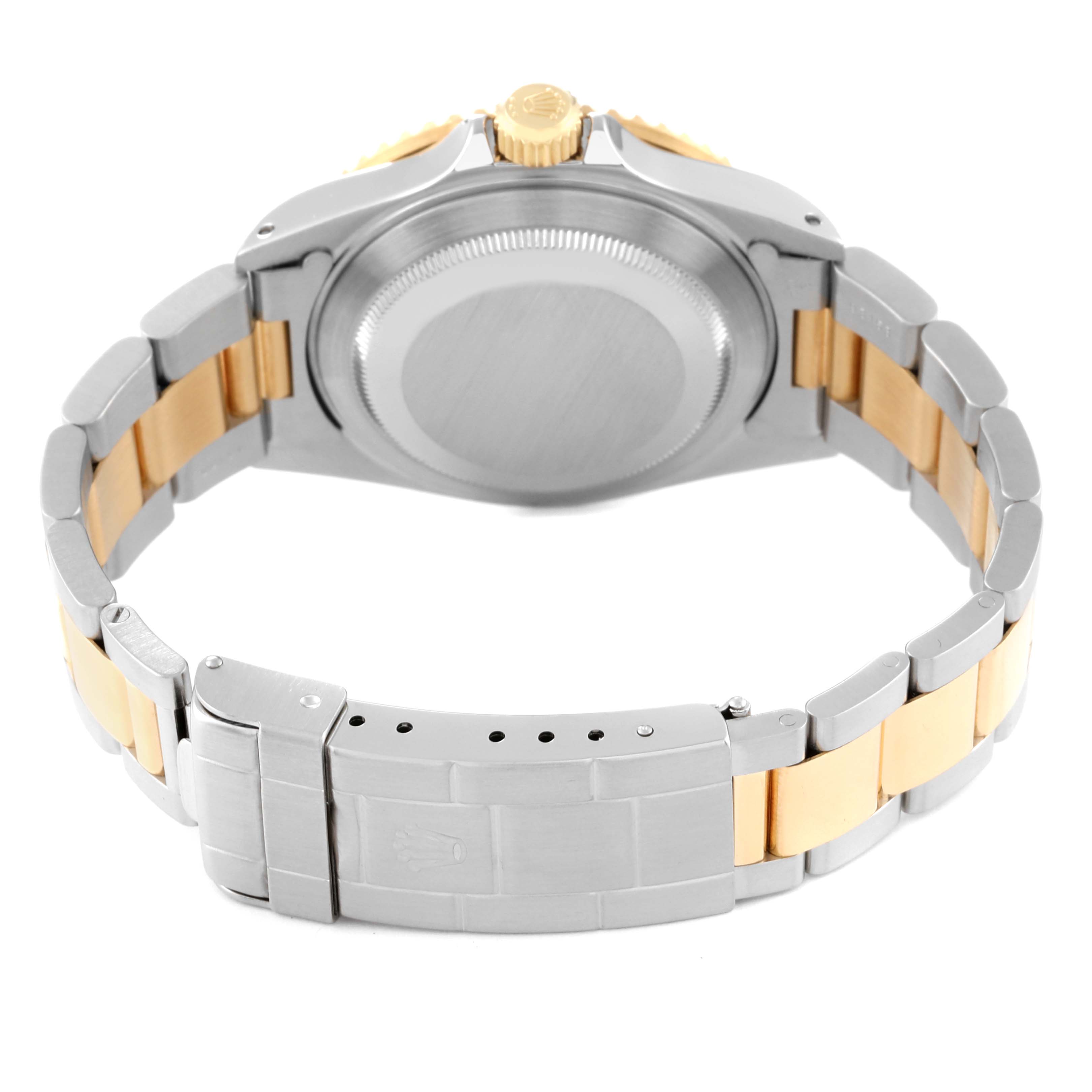 The image shows the back view of a Rolex Submariner 16613 Men
s Steel and Gold (two tone) Blue Dial 16613 Men
s Steel and Gold (two tone) Blue Dial watch, highlighting the case back, crown, and metal bracelet with two-tone links.