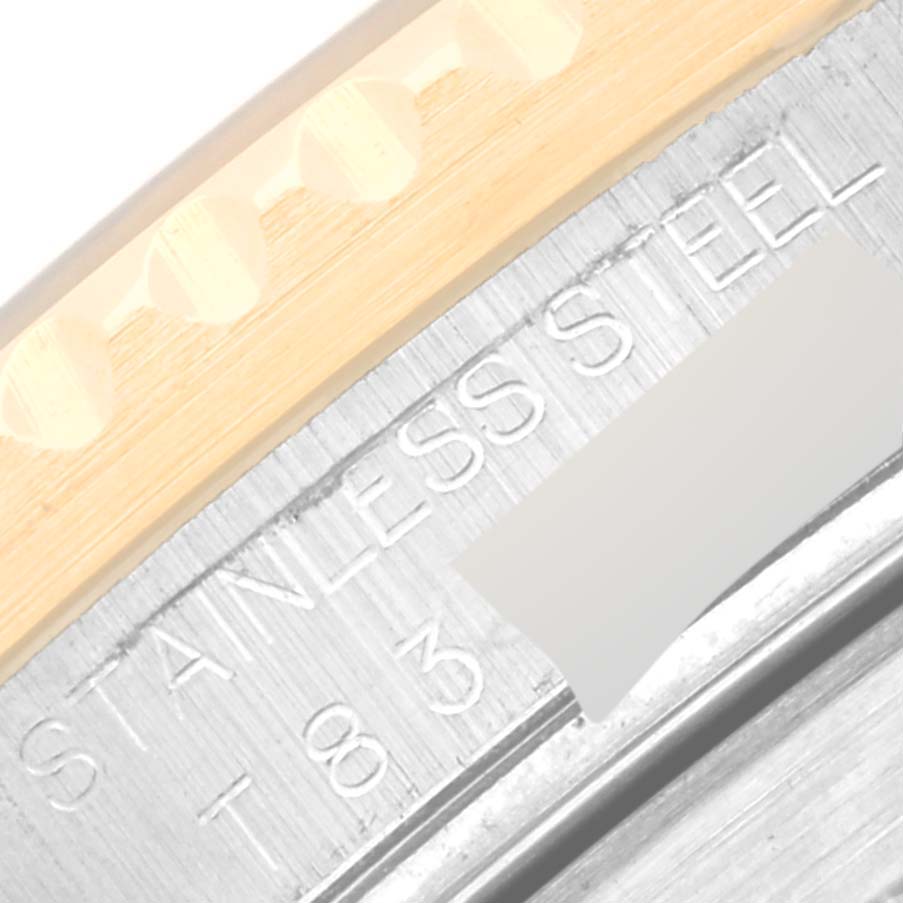 This close-up image shows the edge of the bezel and part of the case back of the Rolex Submariner 16613 Men
s Steel and Gold (two tone) Blue Dial 16613 Men
s Steel and Gold (two tone) Blue Dial watch.