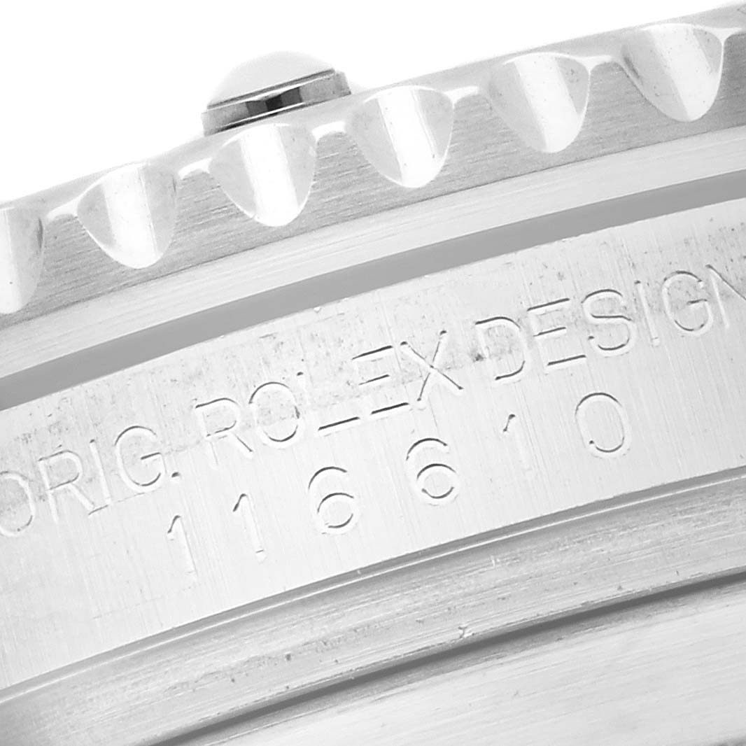 The image shows a close-up of the side of a Rolex Submariner 116610LN Men's Stainless Steel Black Dial 116610LN Men's Stainless Steel Black Dial watch, focusing on the bezel edge and engraved design number.